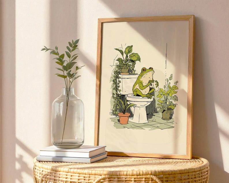Hand drawn poster of a frog on toilet surrounded by plants, frog bathroom art for powder room art and restroom wall art, cute bathroom art with toilet humor art and bathroom humor sign vibe.