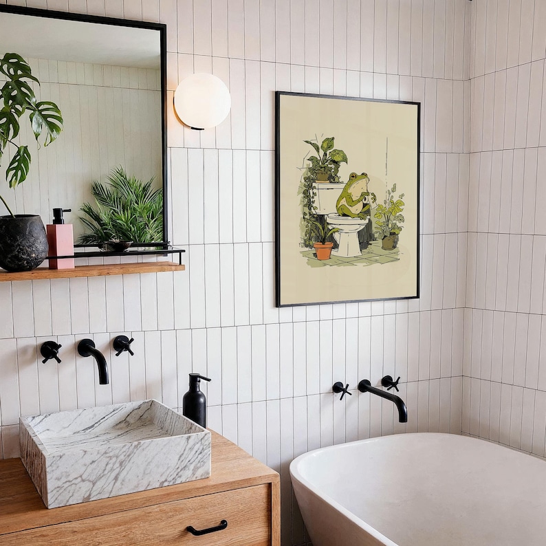 Hand drawn poster of a frog on toilet surrounded by plants, frog bathroom art for powder room art and restroom wall art, cute bathroom art with toilet humor art and bathroom humor sign vibe.