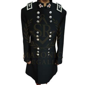 May include: Black Masonic regalia jacket with silver buttons and shoulder details. The jacket has a double-breasted design and features white and red cross emblems on the shoulders and collar. The text "MASONIC REGALIA" is visible on the jacket.
