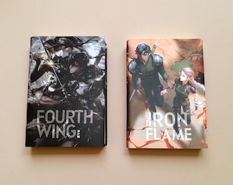 May include: Two graphic novels with black covers. The cover on the left features a black and white illustration of three people with swords. The title "FOURTH WING" is printed in white on the cover. The cover on the right features a color illustration of two people in a desert landscape. The title "IRON FLAME" is printed in white on the cover.
