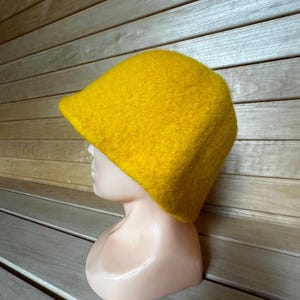 Peut inclure: Un bonnet en laine jaune vif. Le bonnet est doux et moelleux, et il a un design simple et classique.