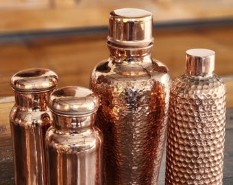 Juego de jarra y botella de agua de cobre martillado, hecho a mano por un artesano indonesio.