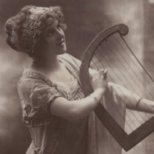 1920 Bella giovane donna in stile greco antico su un piedistallo che suona la lira Antica cartolina francese