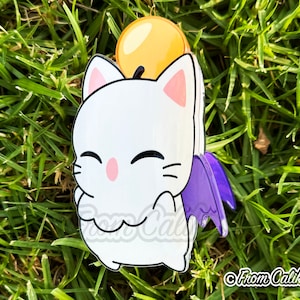 May include: A white cat-like character with a yellow orb on its head and purple wings. The character has a pink nose and ears, and is smiling. The image is set against a background of green grass.