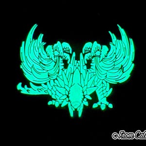 May include: A glowing teal emblem against a black background. The design features a symmetrical, stylized bird or mythical creature with detailed wings and a central body. The text "From Caliko" is in the bottom right corner.