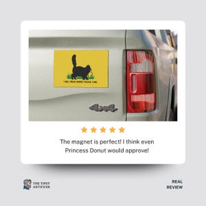 May include: A yellow rectangular car magnet featuring a black cat silhouette with a ball of yarn, set on green grass. The text "I WILL TREAD WHERE I PLEASE CARL" is below the cat. The magnet is attached to a vehicle.