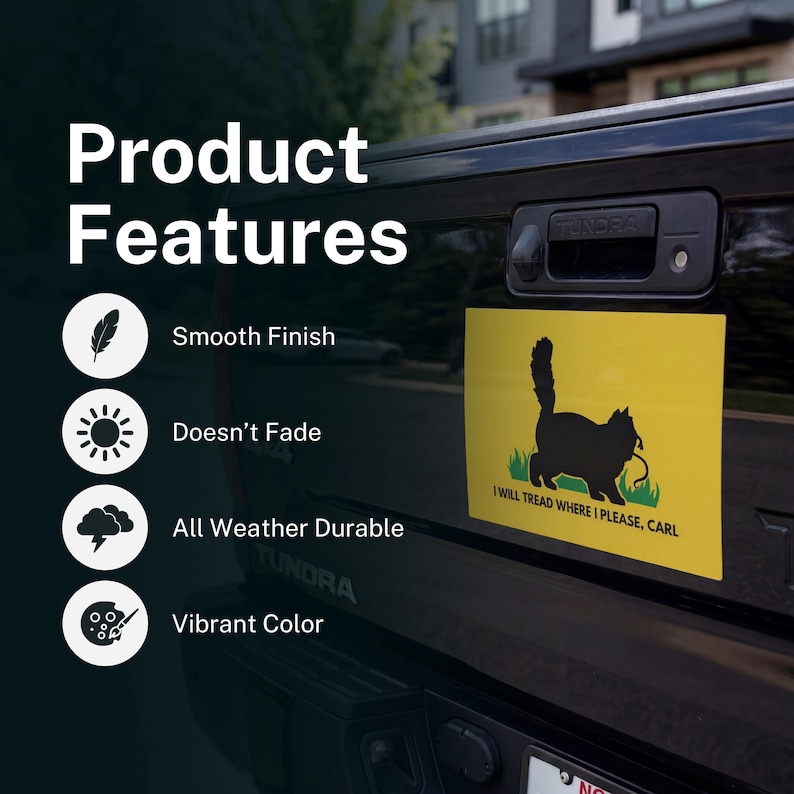 May include: A yellow rectangular sticker featuring a black cat silhouette on a green patch of grass. The text "I WILL TREAD WHERE I PLEASE, CARL" is below the cat. The sticker is on a black vehicle.