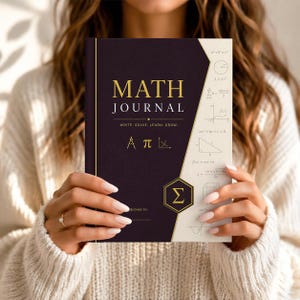May include: A Math Journal with a dark purple cover and gold lettering. The cover reads "MATH JOURNAL" with the words "WRITE. SOLVE. LEARN. GROW." below. The journal includes mathematical symbols and diagrams. The journal is held by a person.