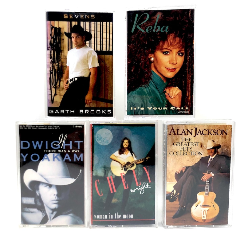 May include: Five vintage cassette tapes featuring country music artists. The tapes include Garth Brooks' "Sevens", Reba's "It's Your Call", Dwight Yoakam's "There Was A Way", Chely Wright's "Woman in the Moon", and Alan Jackson's "Greatest Hits Collection".