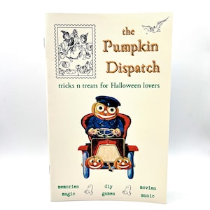 May include: A cream-colored booklet titled "The Pumpkin Dispatch" with a vintage illustration of a pumpkin-headed character driving a car. The cover also features a stamp-like image and the text "tricks n treats for Halloween lovers."