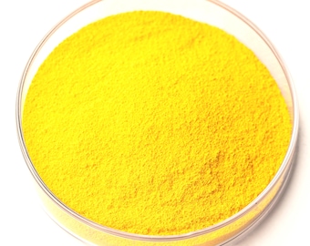 May include: A clear, round petri dish filled with a vibrant yellow powder. The powder has a fine, granular texture and completely fills the dish, creating a solid yellow circle against a white background. The dish's rim is transparent.