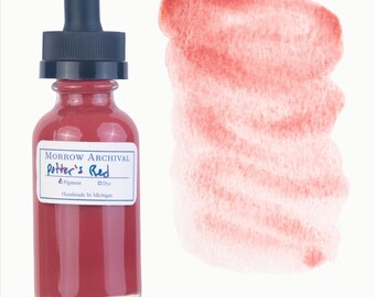 May include: A glass bottle of "Potter's Red" pigment dye with a black dropper top, next to a red watercolor swatch. The label reads "Morrow Archival" and "Handmade In Michigan".
