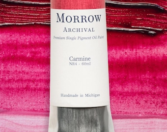 May include: A tube of Morrow Archival oil paint, Carmine color, 60ml. The label is white with red accents and black text. The paint is a deep red color, and the tube is labeled "Handmade in Michigan."