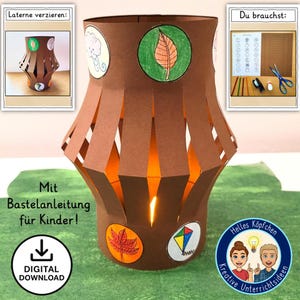 Könnte beinhalten: Eine braune Papierlaterne mit ausgeschnittenen vertikalen Schlitzen, verziert mit farbigen kreisförmigen Bildern eines Blattes, einer Wolke, eines Drachens und eines Herbstblattes. Der Text "Digitaler Download" ist sichtbar. Die Laterne ist von innen beleuchtet.