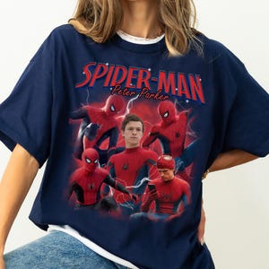 Może przedstawiać: Granatowa koszulka z grafiką Spider-Mana i napisem "SPIDER-MAN Peter Parker" w kolorze czerwonym i białym. Projekt zawiera wiele obraz&oacute;w Spider-Mana w pozach akcji z niebieskim efektem błyskawicy.
