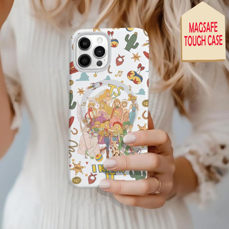 May include: A white smartphone case featuring a MagSafe design and a colorful pattern of cartoon characters, cacti, stars, and musical notes. The central graphic displays a group of animated figures with the text TS and I KNEW IT printed below.