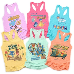 May include: A selection of brightly coloured racerback vests, each adorned with Disney characters and event logos. The vests come in shades like pink, yellow, blue, and orange. Each vest showcases a distinct design linked to a Disney event or race.