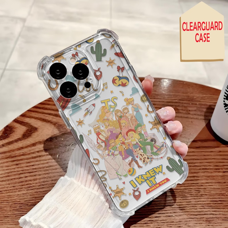 May include: A clear phone case featuring a colorful collage of cartoon characters, cacti, stars, and musical notes. The design includes the text "I KNEW IT" in yellow letters and "I KNEW YOU" in a red box. The case has reinforced corners and camera cutouts.