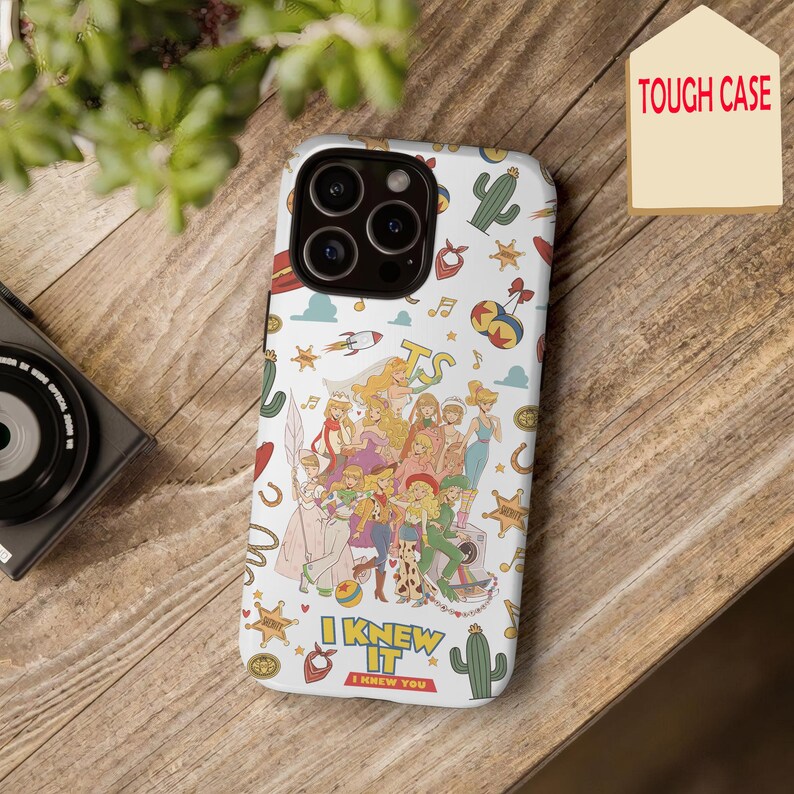 May include: A white phone case featuring a colorful collage of various cartoon characters and icons including cacti, stars, and musical notes. The text "I KNEW IT" is printed in bold yellow letters near the bottom, with "I KNEW YOU" below it.