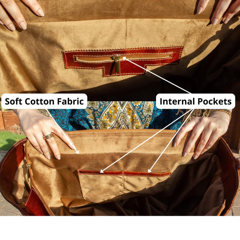 May include: A brown leather bag interior lined with soft cotton fabric. The bag features internal pockets, including one zippered compartment and two open slip pockets. Text labels in the image point to the Soft Cotton Fabric and Internal Pockets.