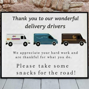 May include: A framed sign with the text "Thank you to our wonderful delivery drivers." The sign features illustrations of delivery vans from USPS, Amazon, and UPS. The text also says "Please take some snacks for the road!"
