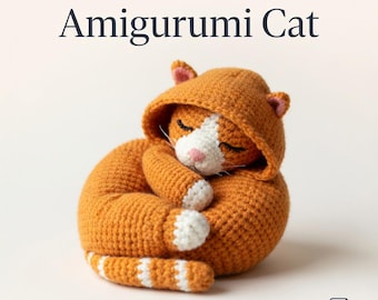 May include: A crocheted orange Amigurumi cat wearing a hooded sweatshirt, curled up in a sleeping position. The cat has white accents on its face and paws, with a pink nose. The text "CROCHET PATTERN PDF" and "Amigurumi Cat" are displayed at the top.