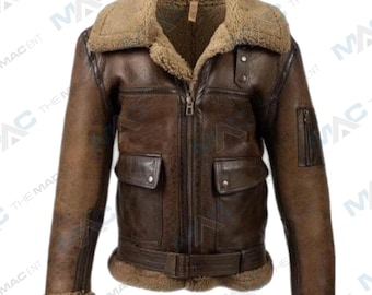 May include: A brown leather jacket with a shearling collar and lining. The jacket features a zip-up front, two front pockets, and a belt at the waist. The sleeves have shearling cuffs. A classic aviator style jacket.