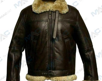 May include: A dark brown leather jacket with a shearling collar and lining. The jacket features a zip-up front, a buckled waist belt, and shearling trim on the cuffs. The jacket has a classic aviator style.