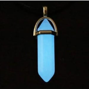 May include: A silver pendant necklace with a light blue glow-in-the-dark crystal point.