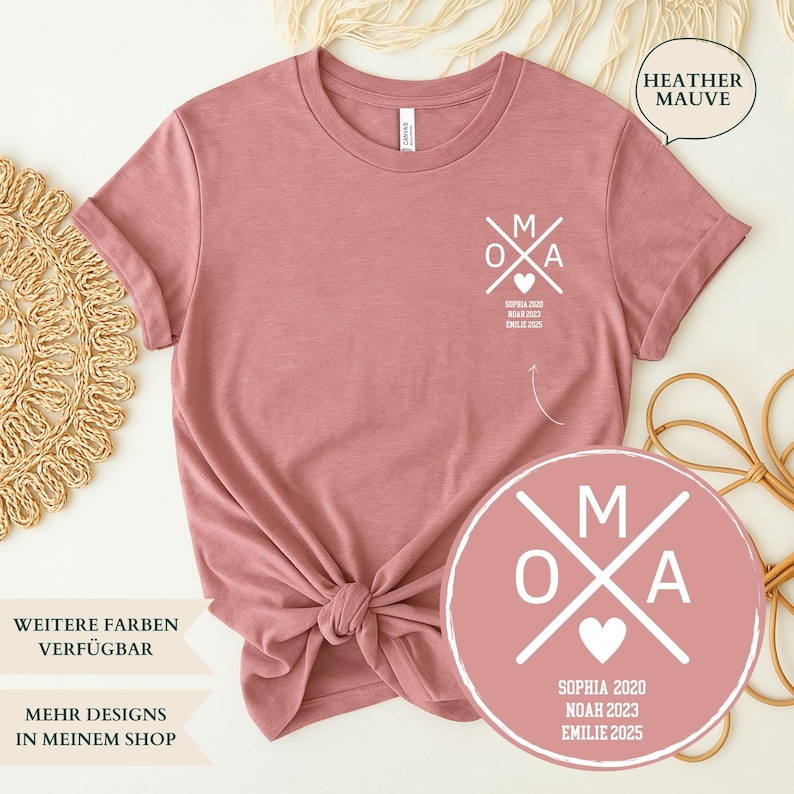 May include: Heather mauve t-shirt with a white graphic that says "OMA" with a heart and the names Sophia, Noah, and Emilie with years. The shirt has a crew neck and short sleeves.