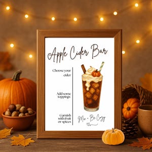 May include: A framed sign with the text "Apple Cider Bar" and a watercolor illustration of an apple cider drink. The image includes pumpkins, fall leaves, and a mug, evoking an autumn theme.