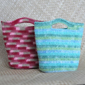 May include: Two crocheted bags, one with pink and brown stripes and the other with blue and green stripes.
