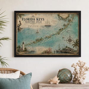 May include: A framed wall art print featuring a vintage-style Florida Keys maritime atlas map. The map displays the islands in shades of blue and tan, with illustrations of a pelican, sailing ships, a lighthouse, a compass rose, and palm trees.