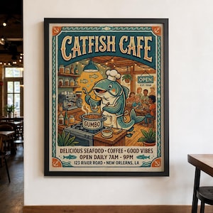 May include: A framed poster titled Catfish Cafe featuring a cartoon catfish wearing a chef hat and apron, stirring a pot labeled Gumbo. The illustration includes a coffee station, dining area, and text: Delicious Seafood, Coffee, Good Vibes, Open Daily 7am-9pm, 123 River Road, New Orleans, LA.
