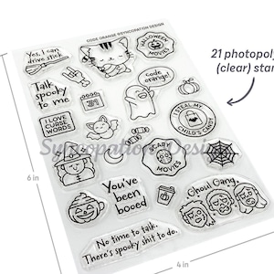 May include: A set of 21 clear photopolymer stamps with a Halloween theme. The stamps feature various designs, including a cat, a ghost, a spiderweb, a pumpkin, and a witch. The text "Code Orange" is printed at the top of the sheet. The stamps are 6 inches tall and 4 inches wide.