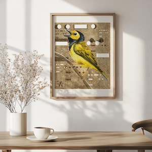 May include: A framed watercolor painting of a yellow and black bird perched on a branch. The bird is set against a textured gold background with geometric shapes. The artwork is displayed in a light wood frame.