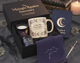 May include: A black gift box with the text "The Midnight Readers Sanctuary" contains a mug, candle, and other items. The mug has floral and crescent moon designs with the text "To the Stars Who Listen...". A navy blue towel with a constellation design is also included.