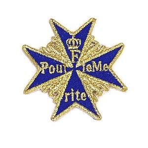 Puede incluir: Un parche bordado azul y dorado con forma de cruz. La cruz tiene una corona y la letra "F" en el centro. Las palabras "Pour le Mérite" están escritas alrededor de la corona. Las palabras "Rite" están escritas en la parte inferior de la cruz.