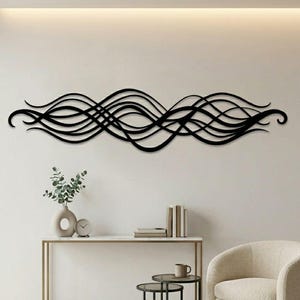 May include: Black metal wall art featuring a flowing, wave-like design. The artwork is mounted on a white wall above a console table. The room is decorated in neutral tones with a modern aesthetic.
