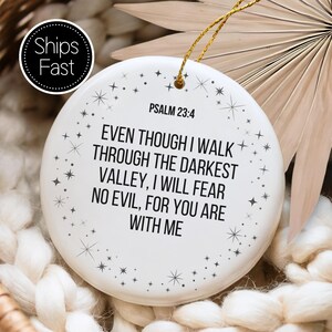 May include: A white ceramic ornament with the text "PSALM 23:4" and a quote about faith. The ornament has a gold string for hanging and is decorated with small star shapes. The words "Ships Fast" are in a black circle.