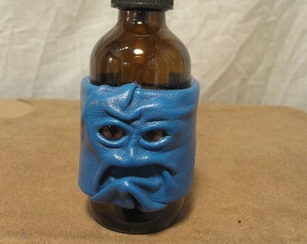 Grichels leather and glass 2oz spray bottle - Caribbean blue with brown slit pupil fox eyes