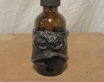 Grichels leather and glass 2oz spray bottle - black with steel blue slit pupil shark eyes