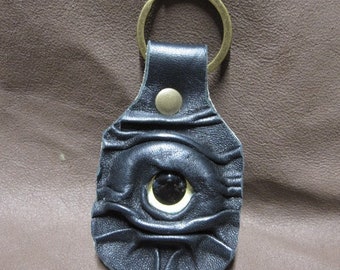 Grichels leather keychain - black with turquoise edged yellow big pupil eye