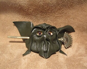 Grichels leather hair thing stick barrette - avocado green with yellow and purple nova eyes