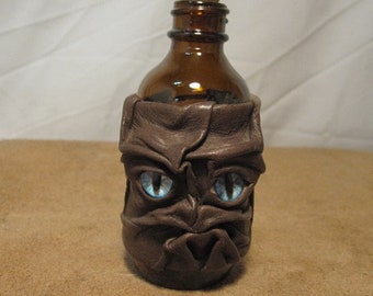 Grichels leather and brown glass small apothecary jar - clay gray brown with aqua blue slit pupil nova eyes