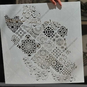 May include: A square white stencil featuring a black map outline of Iran filled with intricate geometric patterns, floral motifs, and Persian calligraphy. The design incorporates various repeating shapes and detailed script elements throughout the map.