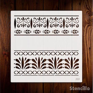 May include: A white stencil with two decorative border designs. The top border features a repeating pattern of stylized leaves and swirls. The bottom border features a repeating pattern of stylized leaves and a chain link design. The stencil is labeled "555 Stencille".