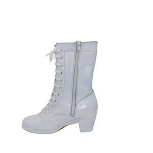 May include: A white, mid-calf boot with a lace-up front and a side zipper. The boot has a small heel and a rounded toe. The material appears to be a patent leather or a similar shiny material. The laces are white.