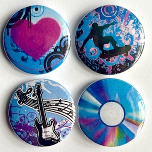 May include: Set of four round buttons with various designs. One button features a pink heart, another a silhouette of a snowboarder, a third a guitar with musical notes, and the last a blue and purple design.