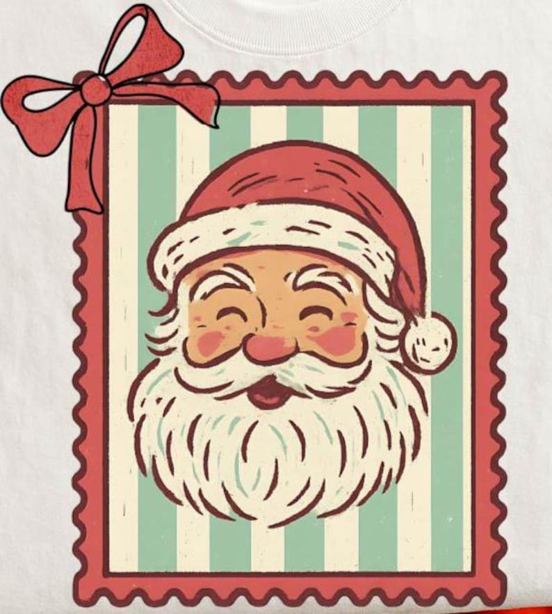 May include: A white t-shirt featuring a vintage-style illustration of Santa Claus. The design is framed within a red postage stamp border, with a red bow at the top left. Santa is depicted with a rosy face, white beard, and a red hat.